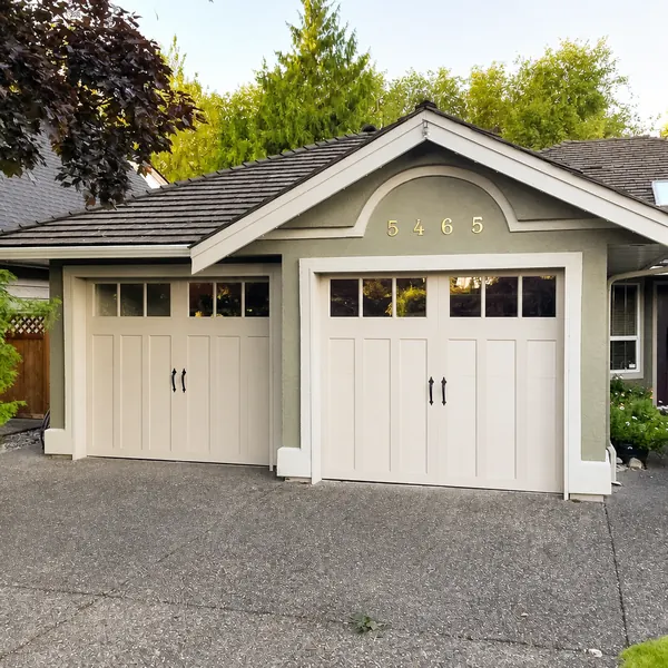 Two beautiful Clopay Coachman garage doors, in model CD13 REC13 windows, Sandtone base and overlay. Coachman doors are a great way to transf