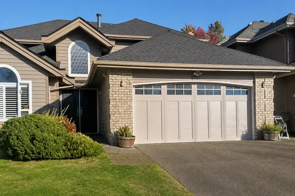 Another happy customer with this Coachman door by Clopay with arched windows and obscure glass in Sandtone base and overlay.