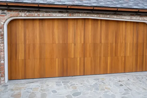 This commercial steel door by Clopay was covered with a custom wood application to give it the exact design the owners were looking for. It 