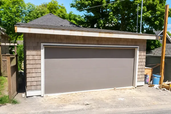 J.Mac Garage Doors recently installed this new construction bronze, flush garage door in Vancouver, BC.